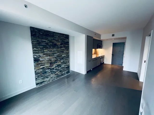 a view of empty room with furniture and fireplace