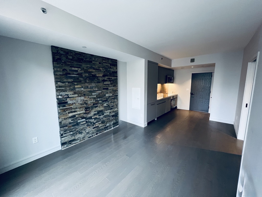 55 Lagrange Street, Unit 1108 Boston, MA 02116 - Photo 6 of 33 a view of empty room with furniture and fireplace