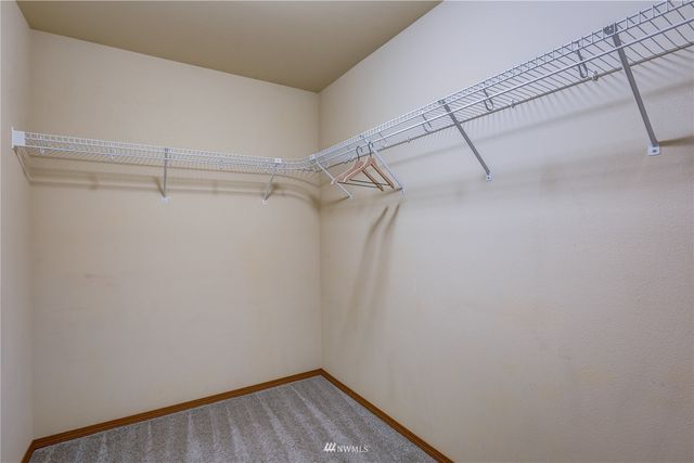 a bathroom with a granite countertop sink mirror and a bathtub