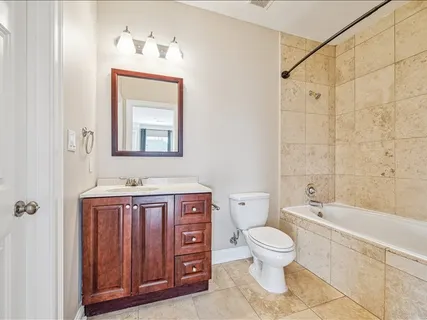 a bathroom with a toilet a sink and bathtub