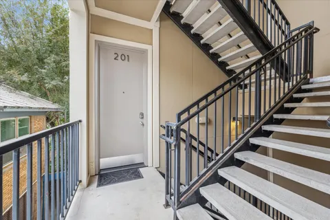 a view of staircase with railing and stairs