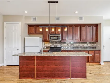 a kitchen with stainless steel appliances granite countertop a stove and a sink