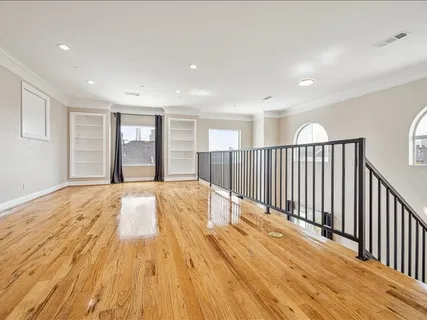 a view of a room with wooden floor