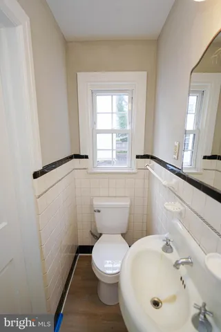a white toilet sitting next to a bathroom sink
