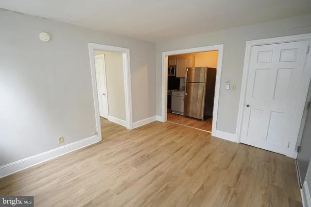 an empty room with wooden floor and closet