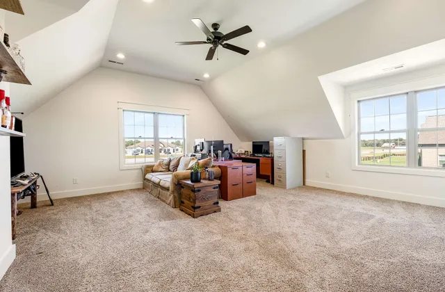 a living room with furniture a flat screen tv and a window