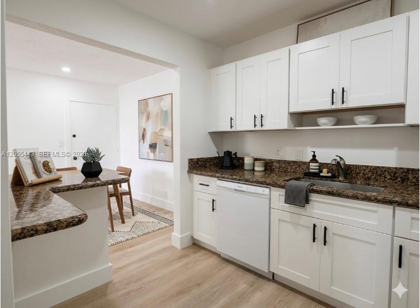 9006 Southwest 137th Street, Unit 18 Miami, FL 33176 - Photo 1 of 13 a kitchen with stainless steel appliances granite countertop a sink stove and white cabinets with wooden floor