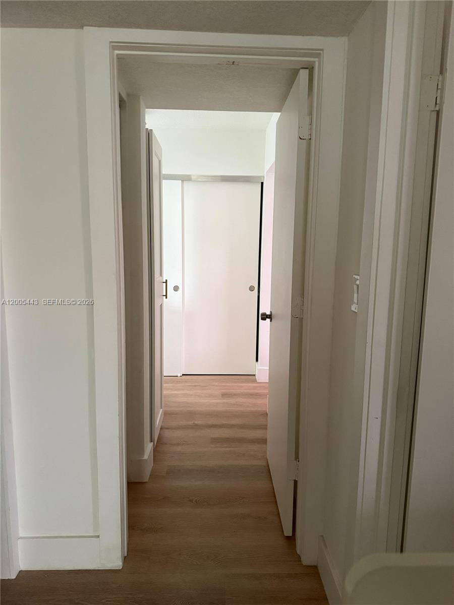 9006 Southwest 137th Street, Unit 18 Miami, FL 33176 - Photo 5 of 13 a view of a hallway with wooden floor