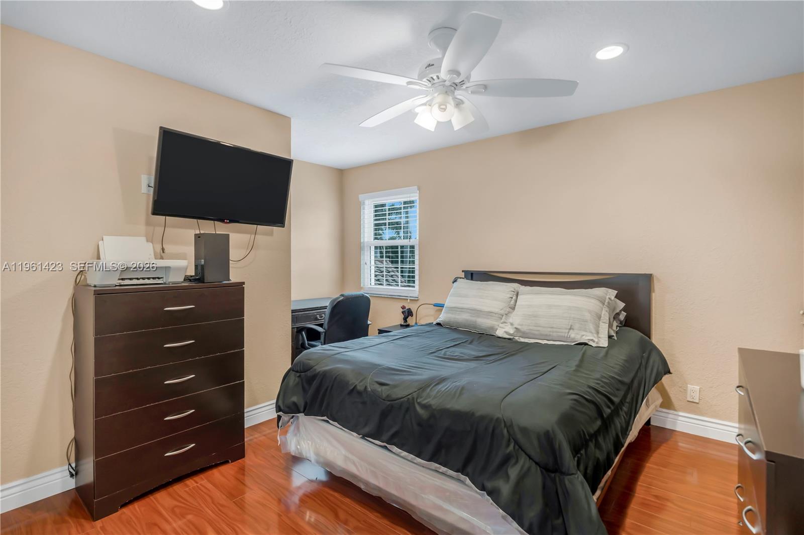 21451 Sawmill Court Boca Raton, FL 33498 - Photo 18 of 67 a bedroom with a bed and a flat screen tv