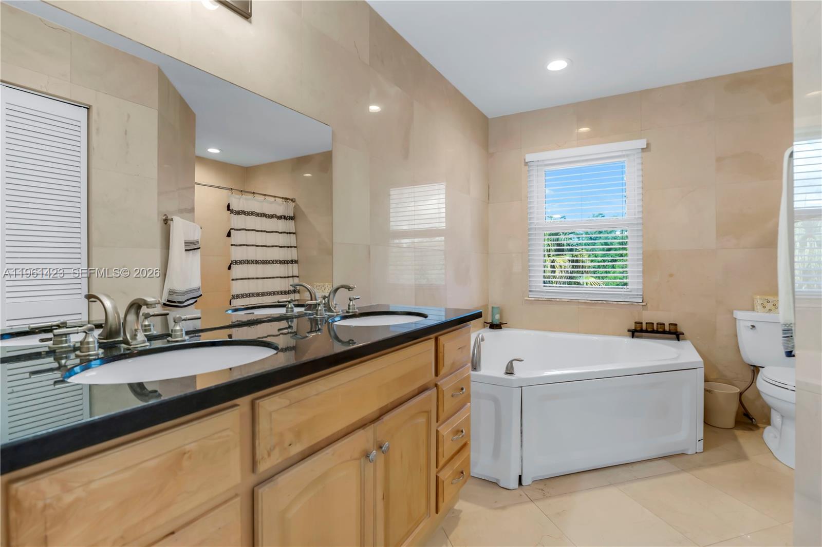 21451 Sawmill Court Boca Raton, FL 33498 - Photo 22 of 67 a bath room with a sink and a bathtub