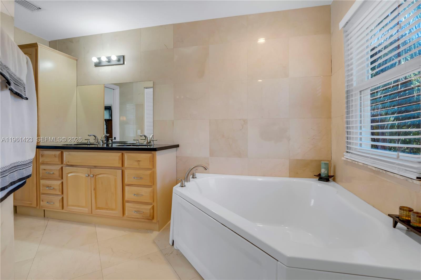 21451 Sawmill Court Boca Raton, FL 33498 - Photo 23 of 67 a bathroom with a granite countertop sink and a mirror
