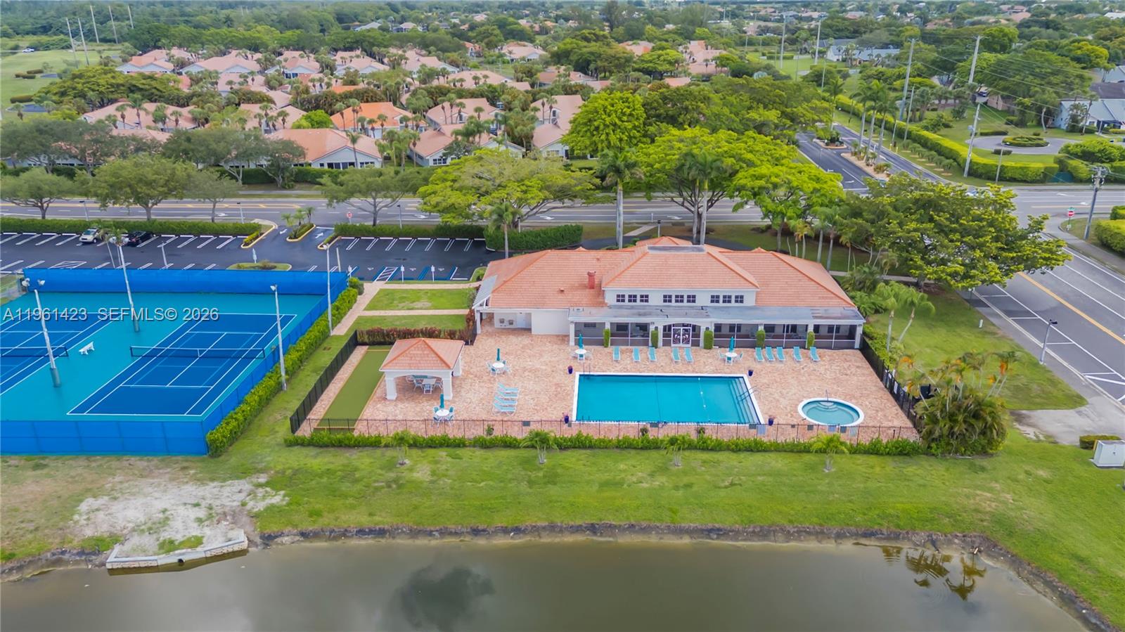 21451 Sawmill Court Boca Raton, FL 33498 - Photo 59 of 67 a aerial view of a house with a yard and lake view