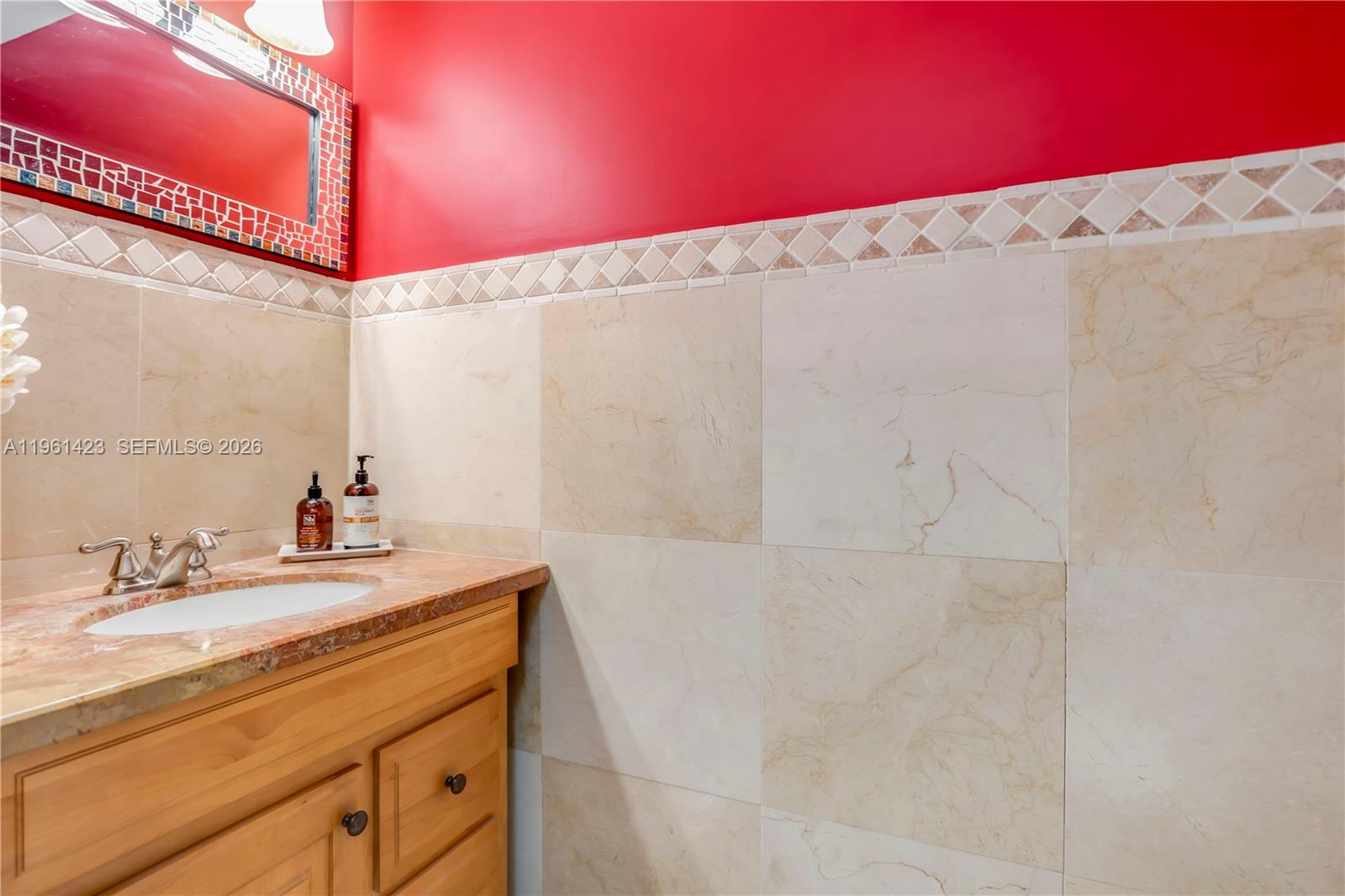 21451 Sawmill Court Boca Raton, FL 33498 - Photo 6 of 67 a bathroom with a sink and a mirror