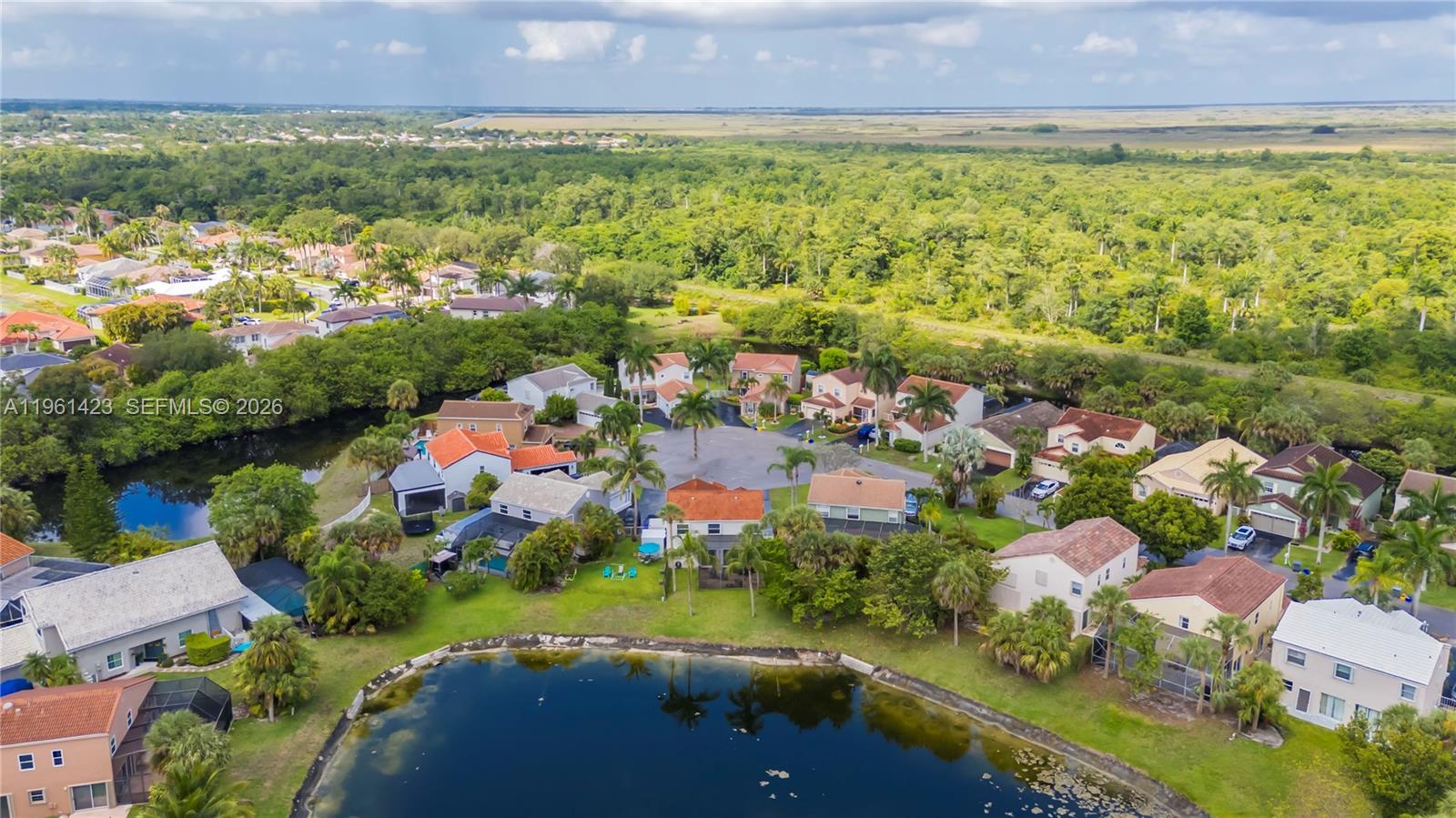 21451 Sawmill Court Boca Raton, FL 33498 - Photo 63 of 67 an aerial view of residential houses with outdoor space and trees