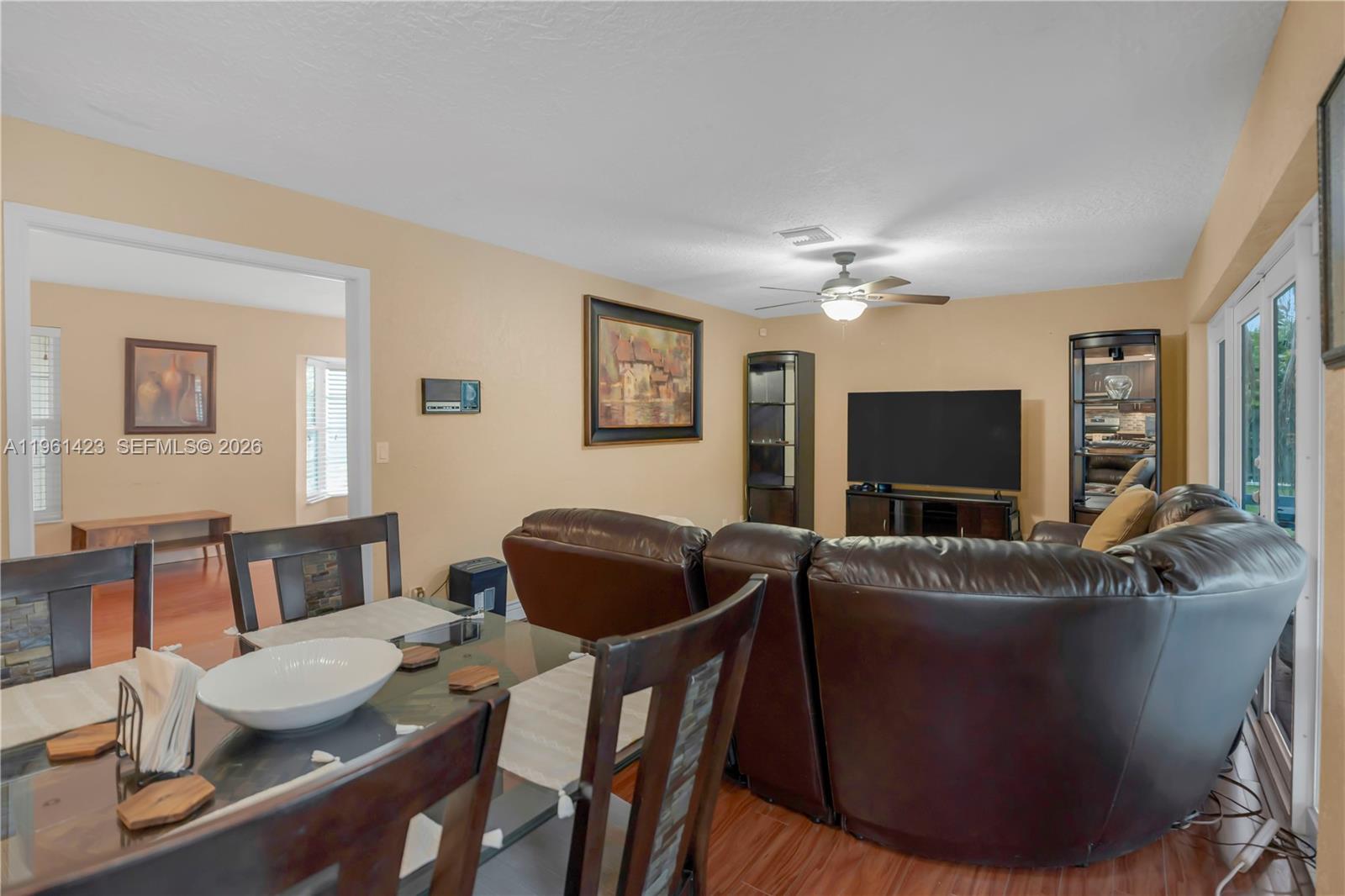 21451 Sawmill Court Boca Raton, FL 33498 - Photo 9 of 67 a living room with furniture and a flat screen tv