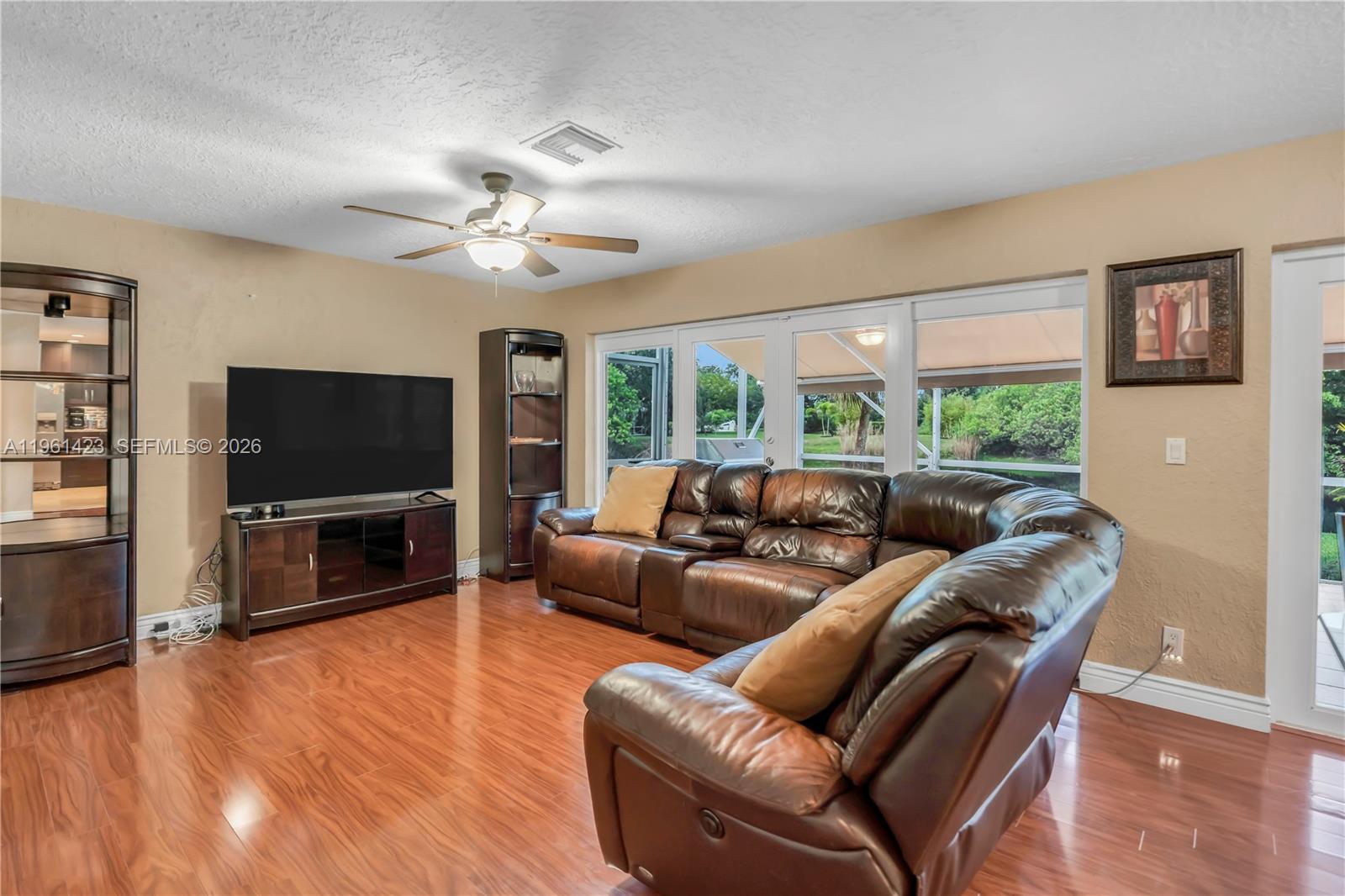 21451 Sawmill Court Boca Raton, FL 33498 - Photo 10 of 67 a living room with furniture and a flat screen tv