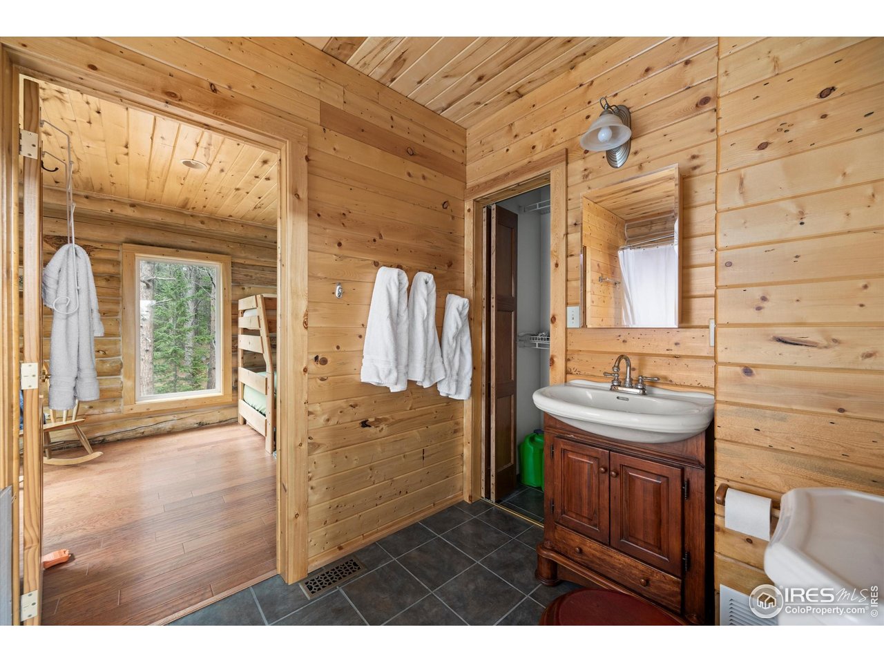 122 Elk Way Drake, CO 80515 - Photo 24 of 43 a bathroom with a sink a mirror and next to a window