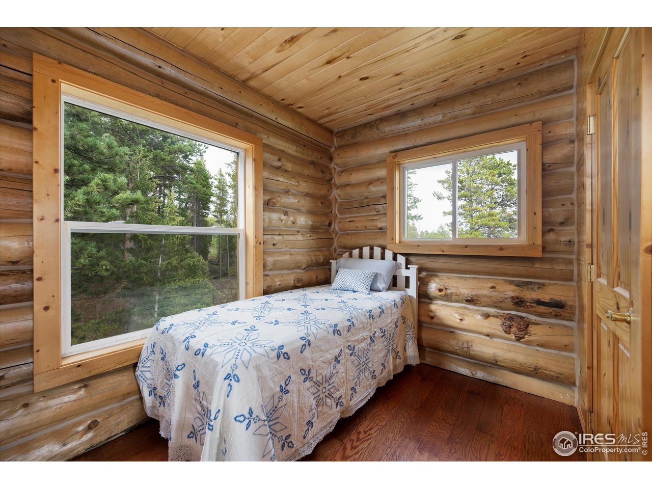 122 Elk Way Drake, CO 80515 - Photo 25 of 43 a bedroom with a bed and a large window