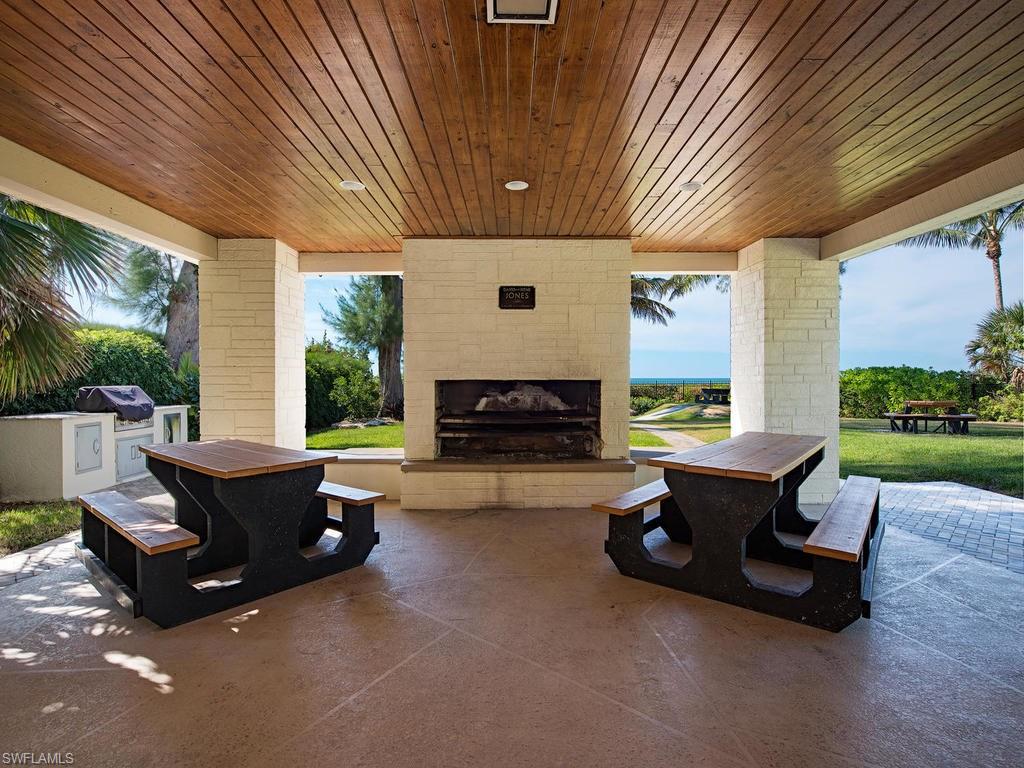 5138 Starfish Avenue Naples, FL 34103 - Photo 16 of 17 a building outdoor space with patio furniture and potted plants