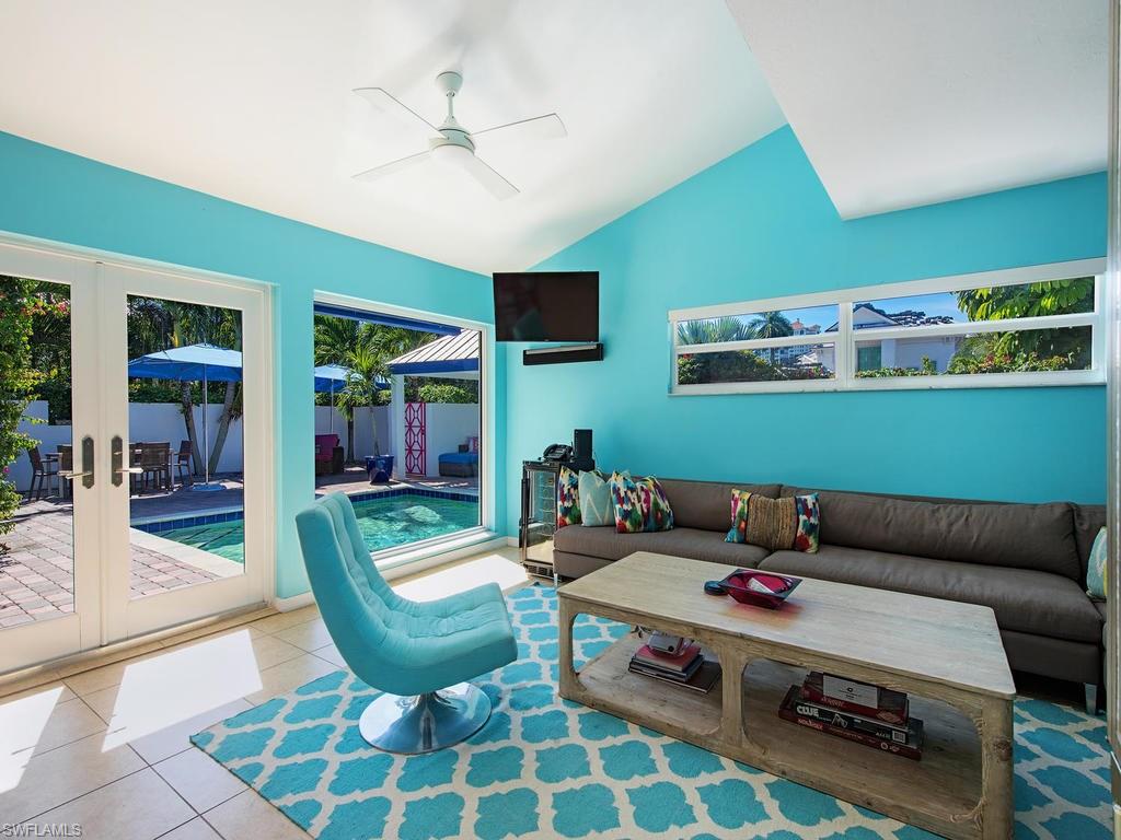5138 Starfish Avenue Naples, FL 34103 - Photo 7 of 17 a living room with furniture and a rug