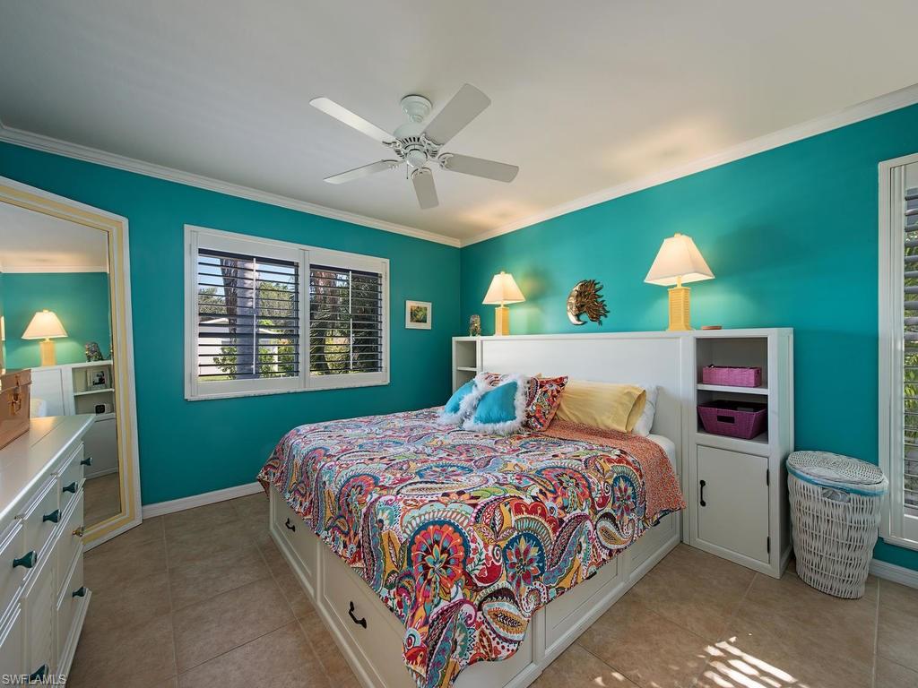 5138 Starfish Avenue Naples, FL 34103 - Photo 8 of 17 a bedroom with a bed and a window