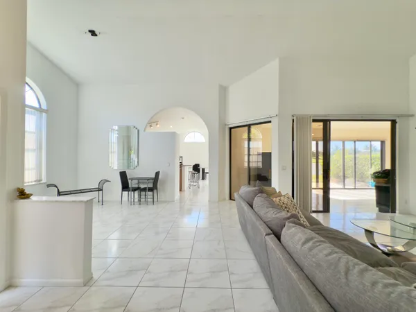 a living room with furniture and large windows
