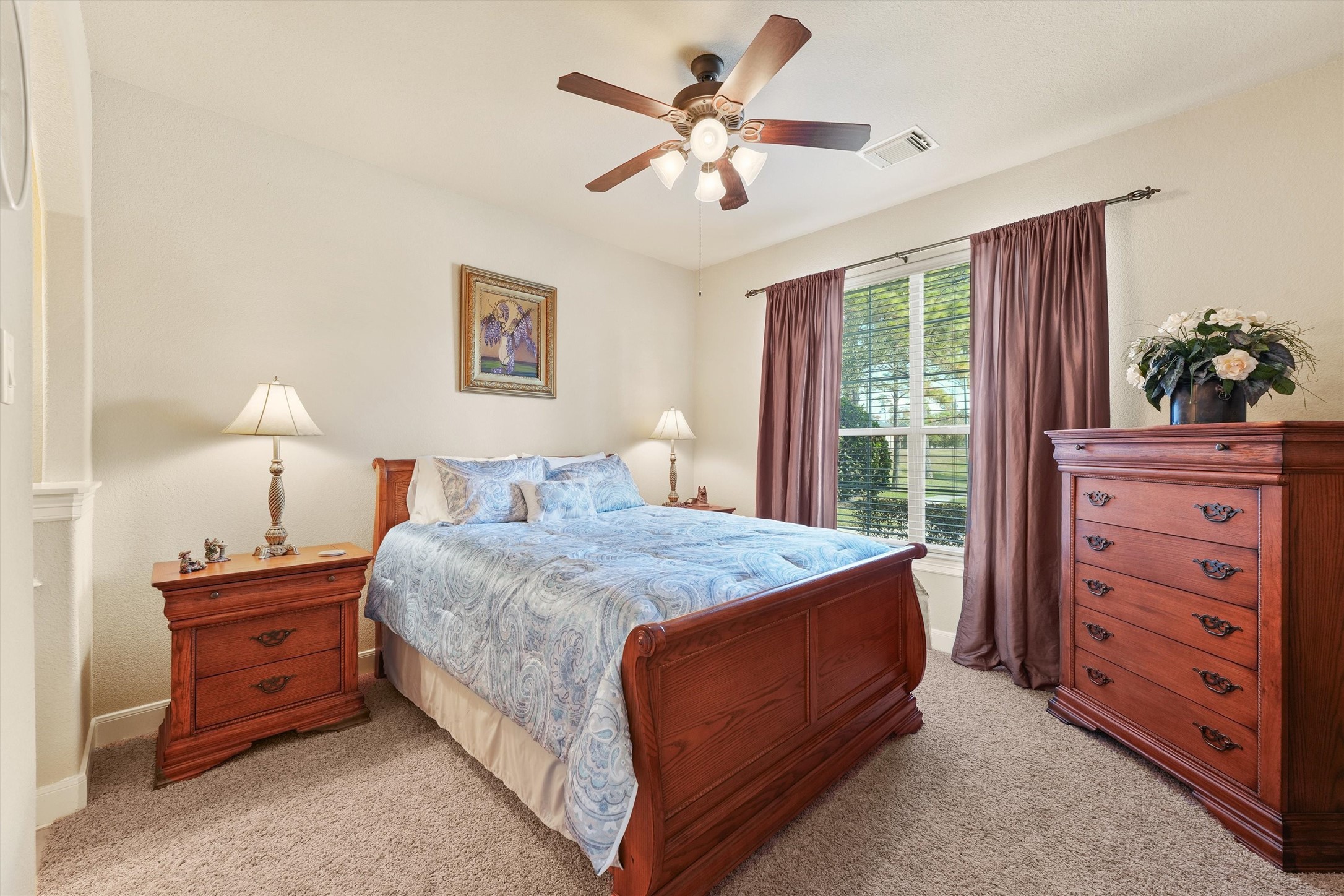 15702 Bellforest Court Houston, TX 77044 - Photo 12 of 38 a bedroom with a bed and a dresser