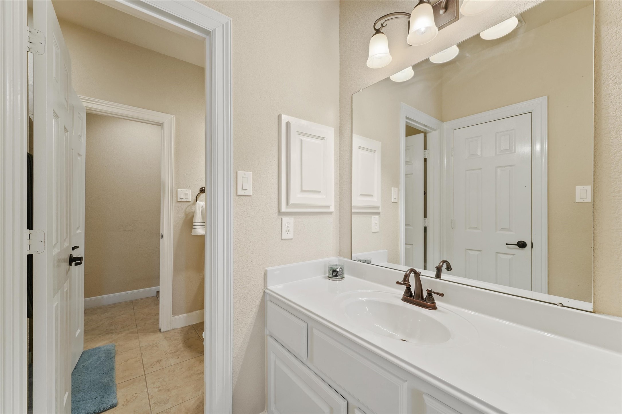15702 Bellforest Court Houston, TX 77044 - Photo 13 of 38 a bathroom with a sink a mirror and a shower