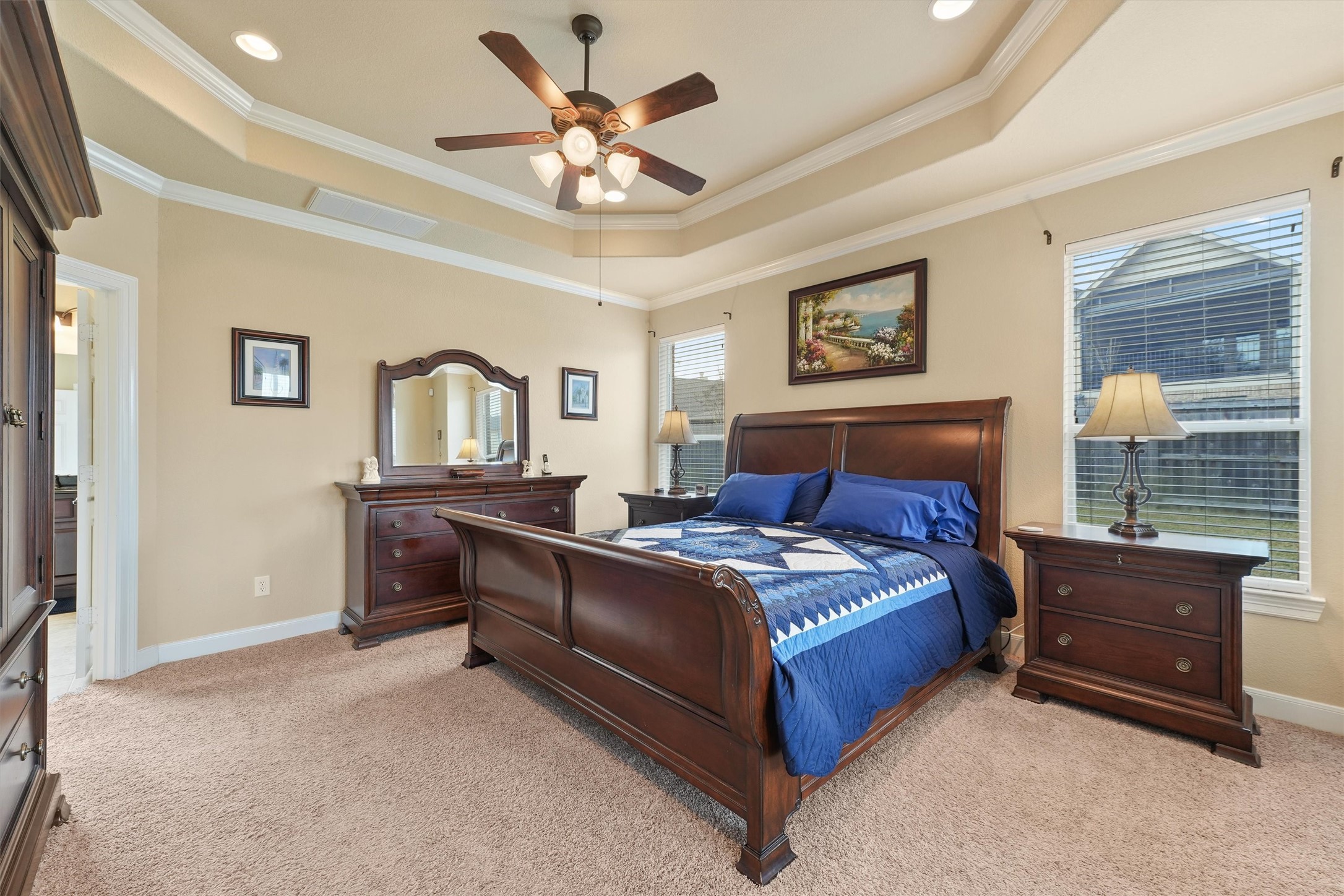 15702 Bellforest Court Houston, TX 77044 - Photo 15 of 38 a bedroom with a bed and a chandelier