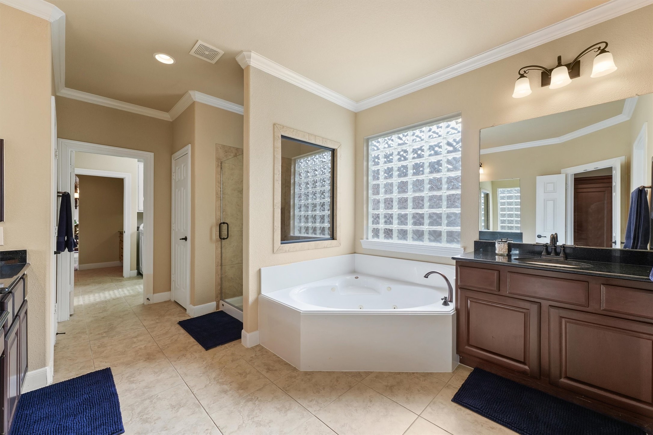 15702 Bellforest Court Houston, TX 77044 - Photo 16 of 38 a spacious bathroom with a tub sink and mirror
