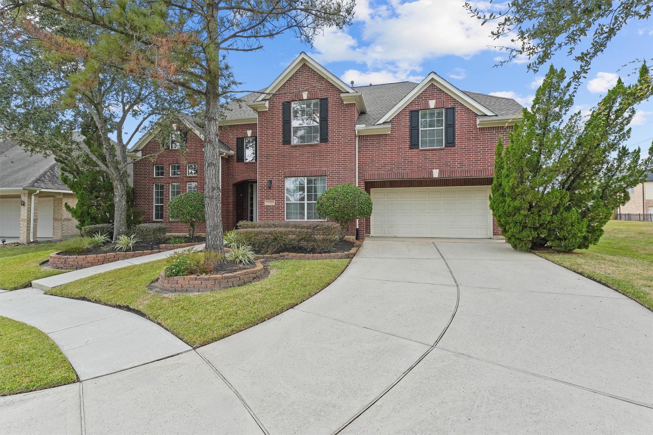 15702 Bellforest Court Houston, TX 77044 - Photo 2 of 38 a front view of a house with a yard and trees