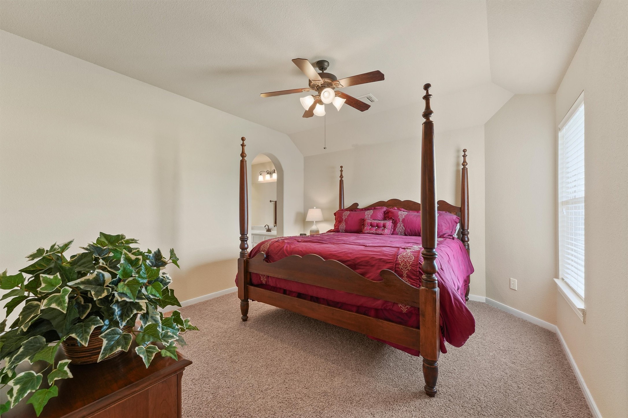 15702 Bellforest Court Houston, TX 77044 - Photo 22 of 38 a bedroom with a bed and a chandelier