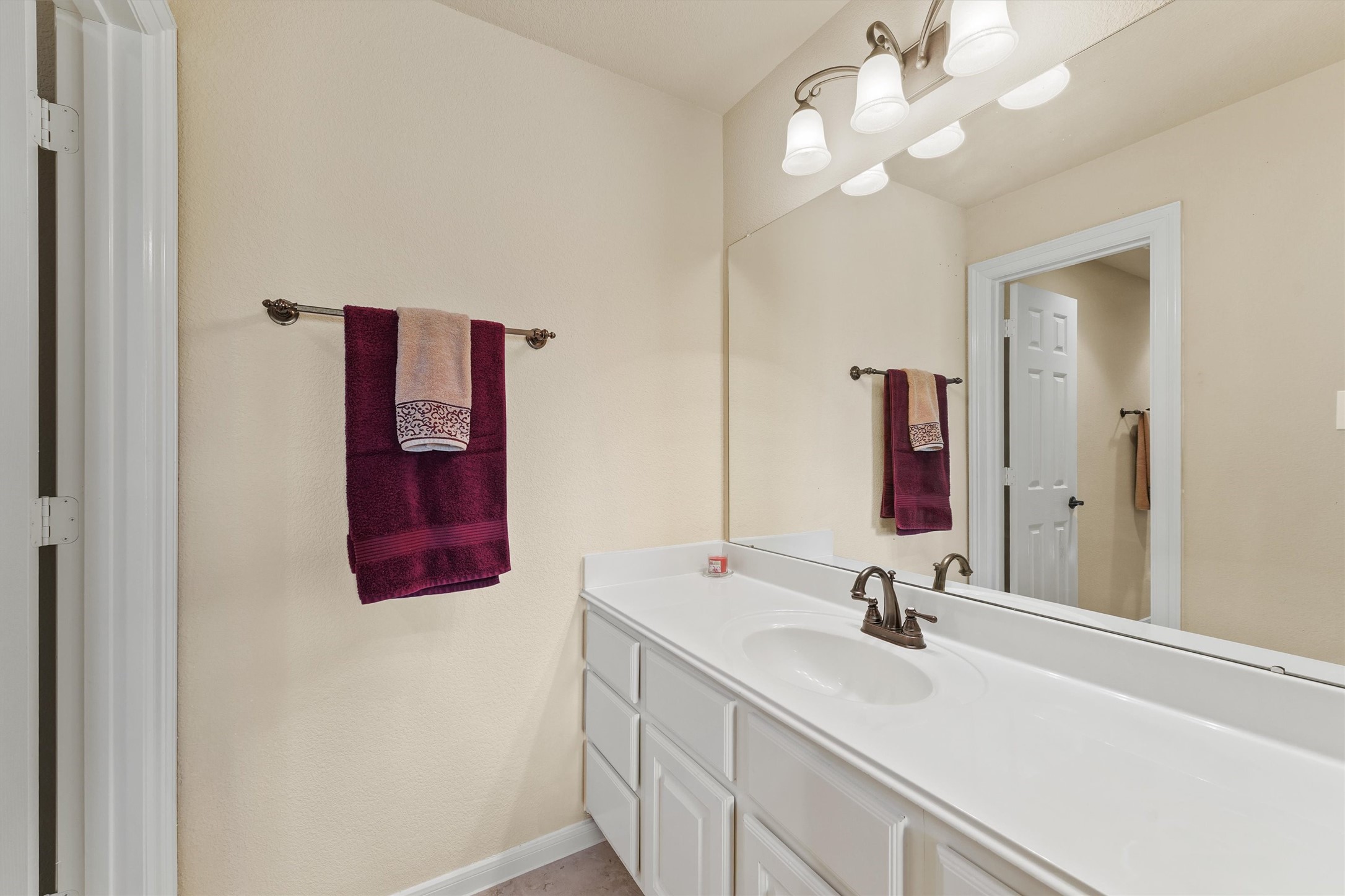 15702 Bellforest Court Houston, TX 77044 - Photo 23 of 38 a bathroom with a sink and a mirror