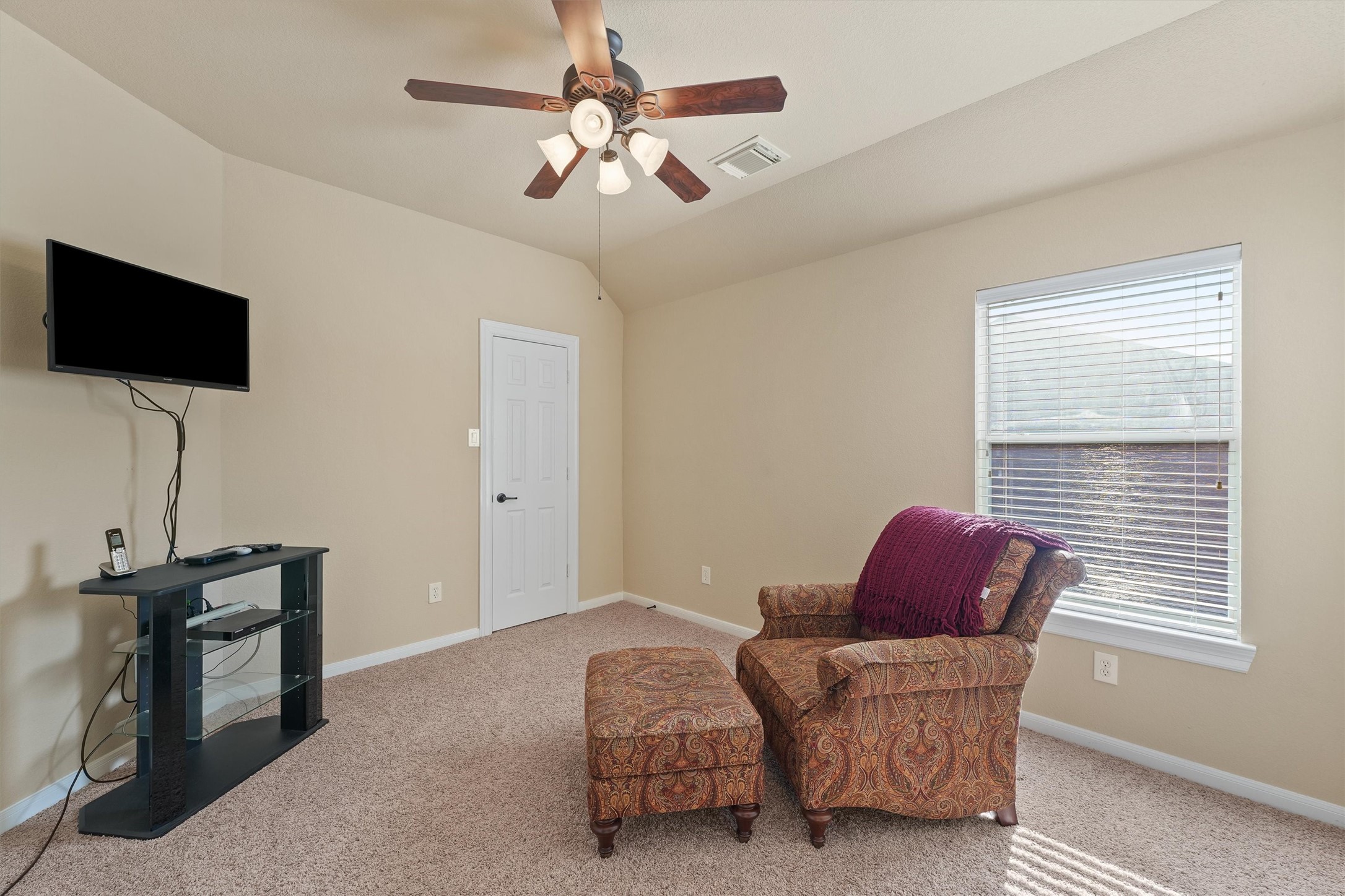 15702 Bellforest Court Houston, TX 77044 - Photo 24 of 38 a living room with furniture and a flat screen tv