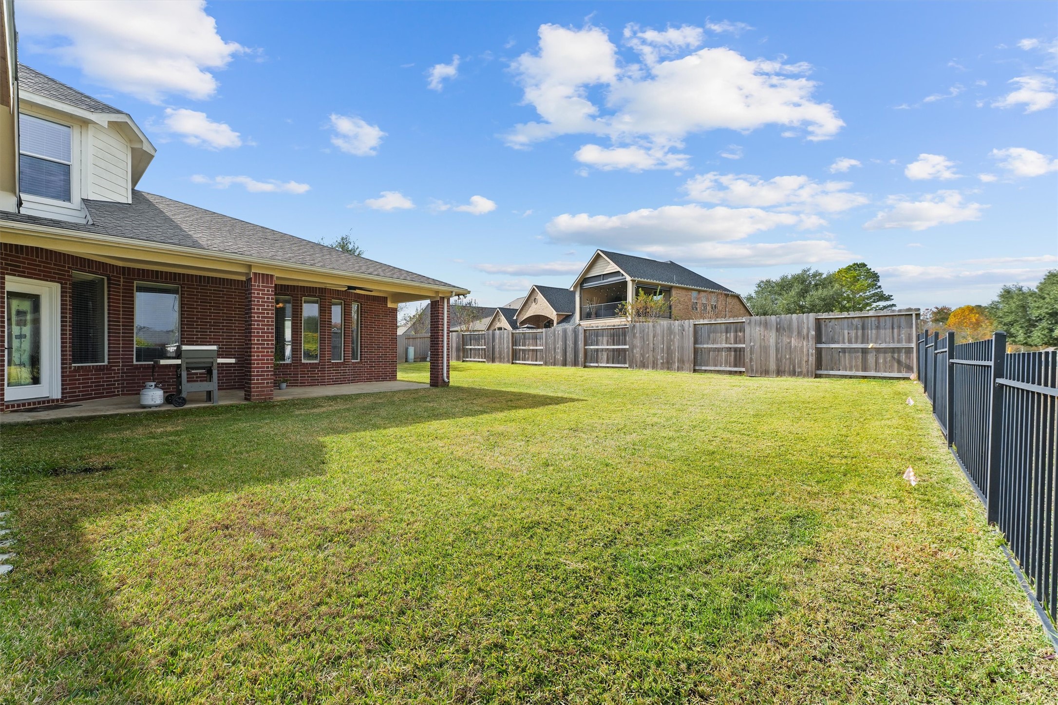 15702 Bellforest Court Houston, TX 77044 - Photo 33 of 38 a view of a house with a backyard and porch