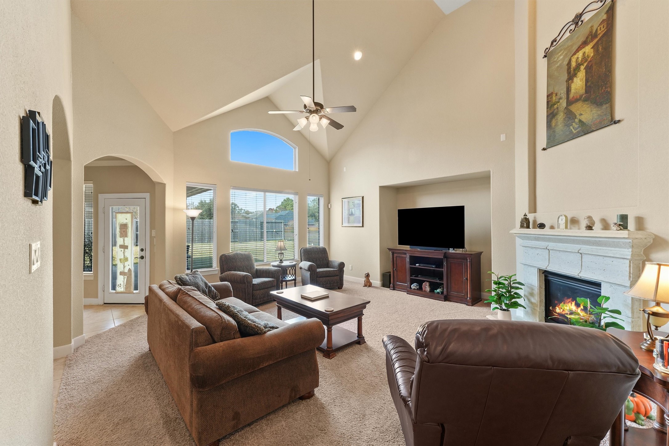 15702 Bellforest Court Houston, TX 77044 - Photo 6 of 38 a living room with furniture a fireplace and a flat screen tv