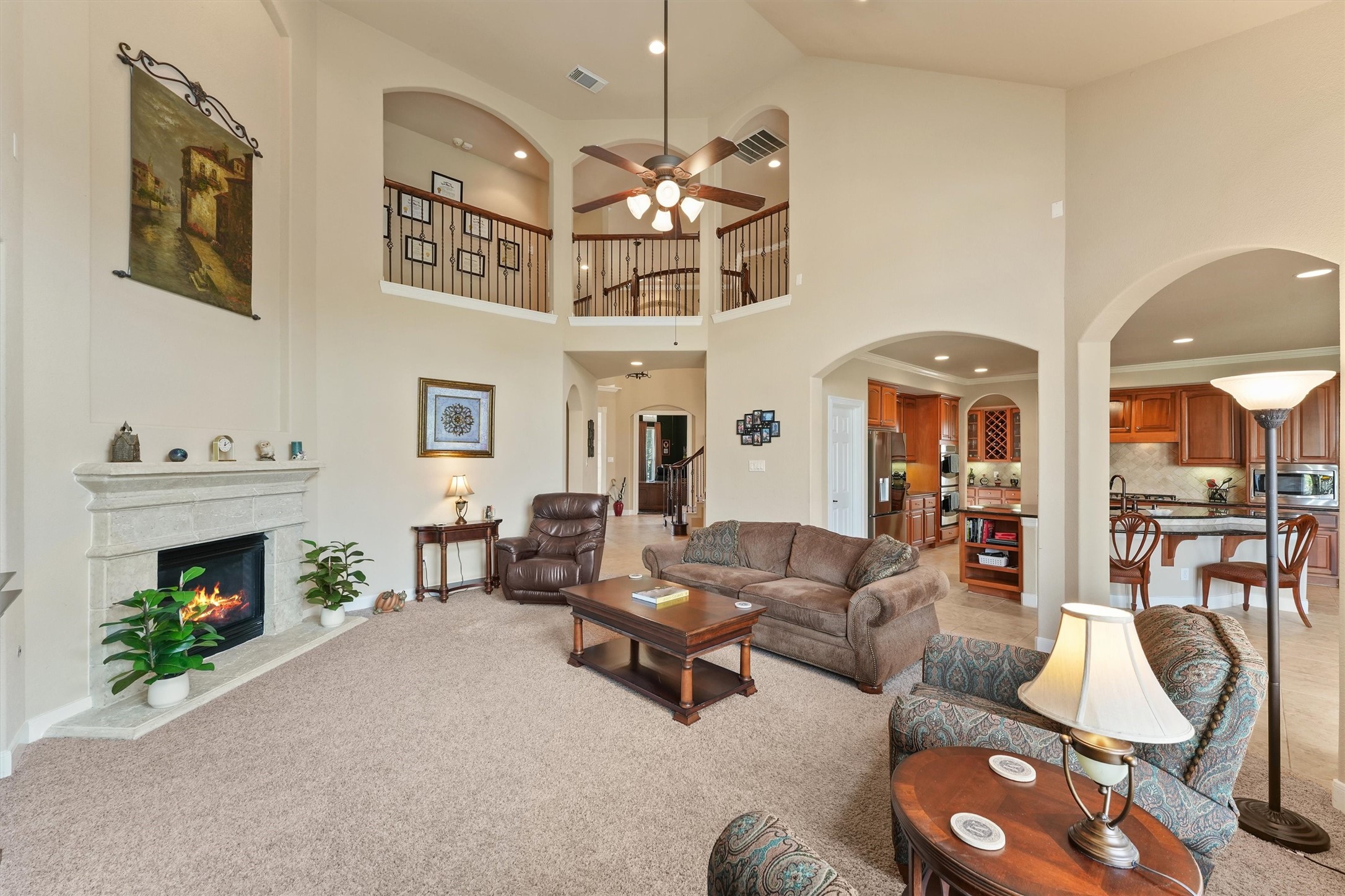 15702 Bellforest Court Houston, TX 77044 - Photo 7 of 38 a living room with furniture a fireplace and a chandelier