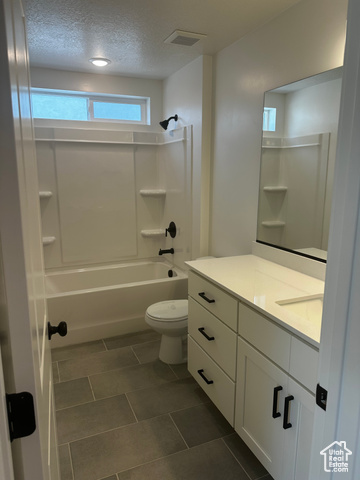 22 South Starlight Lane Mapleton, UT 84664 - Photo 12 of 17 Full bathroom featuring vanity, shower combination, a textured ceiling, and tile patterned floors