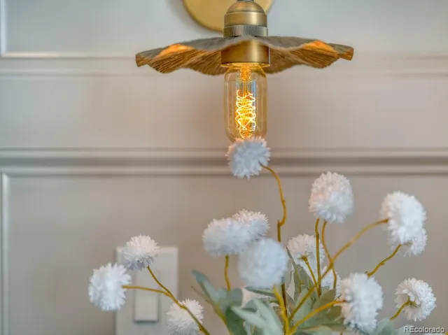 a vase of flowers sitting on a shelf
