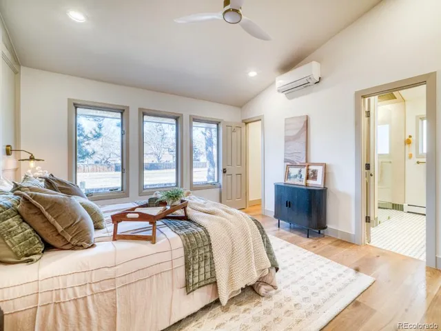 a bedroom with a bed and a large window