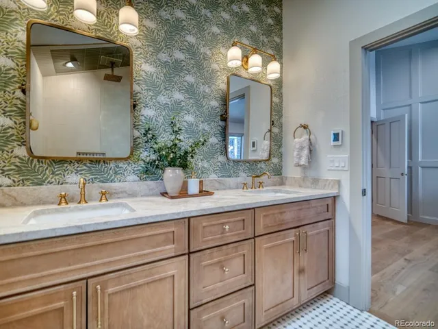 a bathroom with a double vanity sink and a mirror