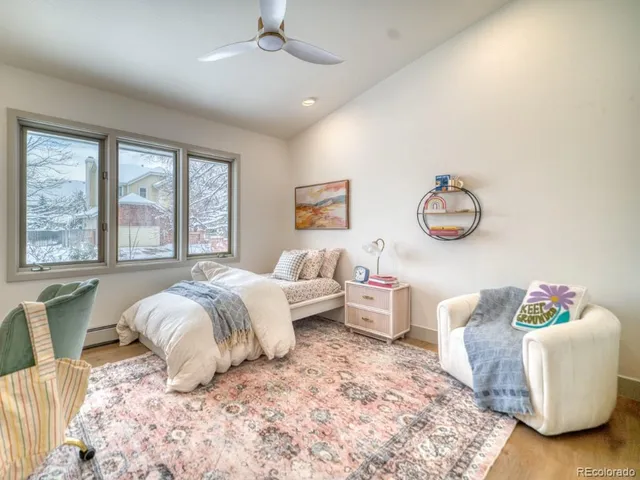 a bedroom with bed and a large mirror