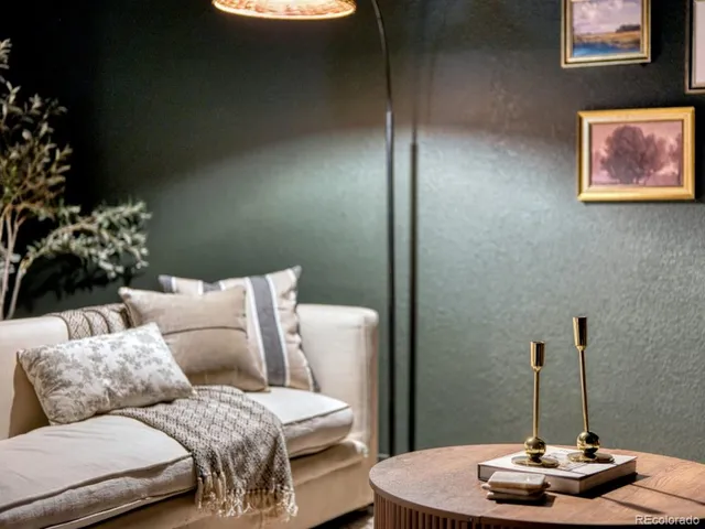 a living room with furniture and a lamp