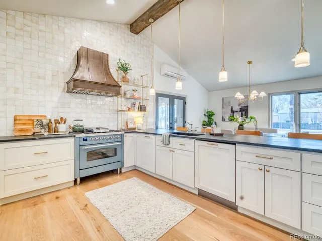 a kitchen with granite countertop white cabinets and white appliances