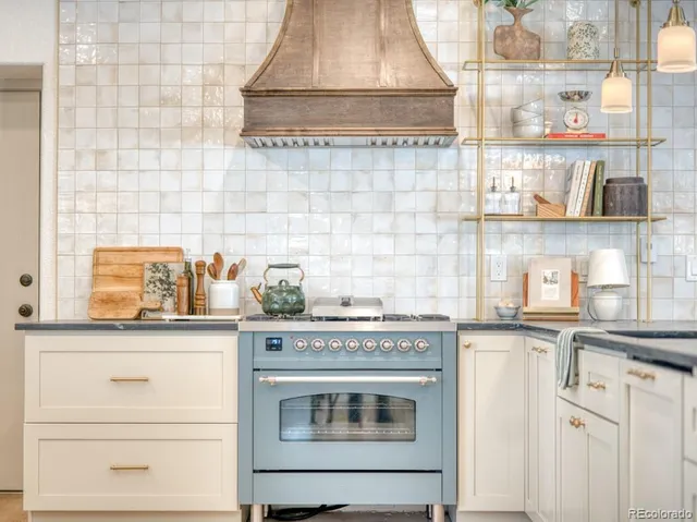 a kitchen with granite countertop white cabinets and white appliances
