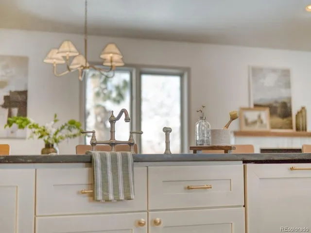 a dining table with a vase of flowers sitting on a table