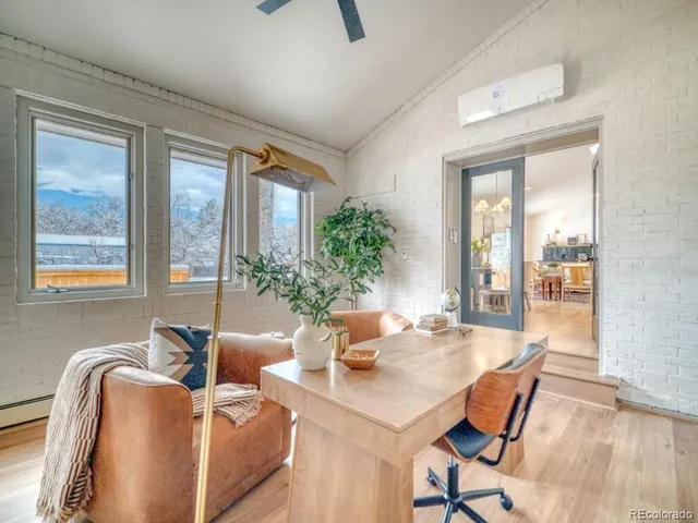 a dining room with furniture and wooden floor