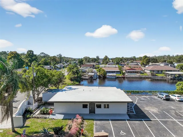 a view of a patio with dining table and chairs with wooden floor
