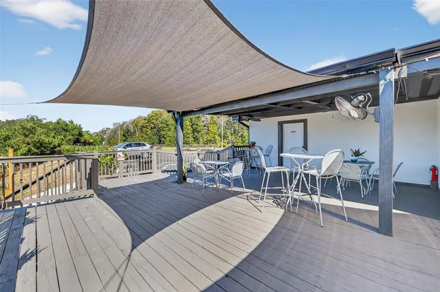 a view of a balcony with chairs and wooden floor