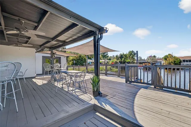a front view of a house with a garden and mountain view